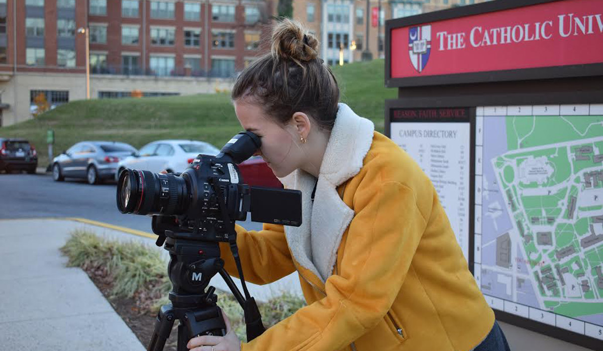 Student filming on campus